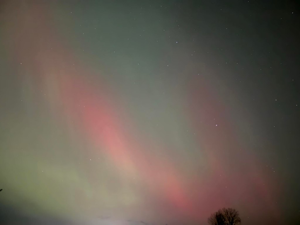 pink and green streaks with little bright stars