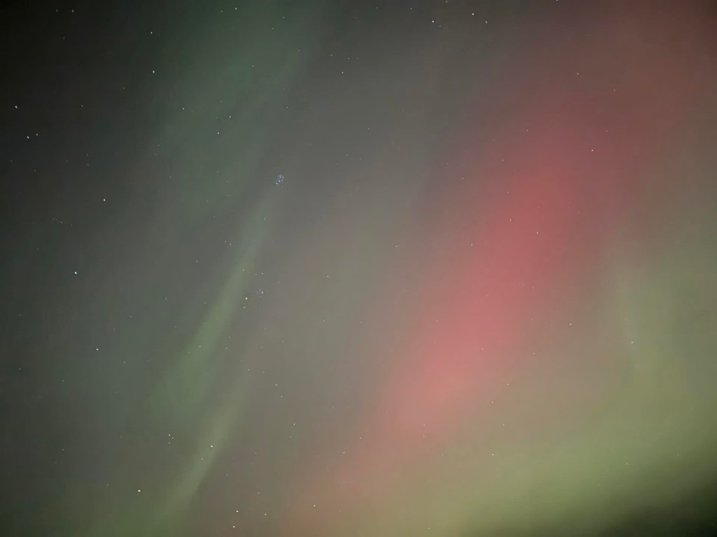 pink green streaks, lots of pink, some dark of the night sky